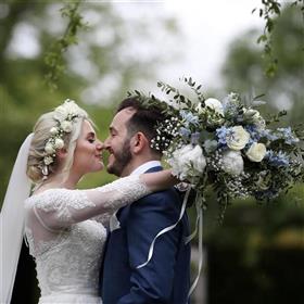 fwthumbSummer bridal hand-tied bouquet in a loose style using white peonies blue delphiniums Lilys Flowers Lightwater1.jpg